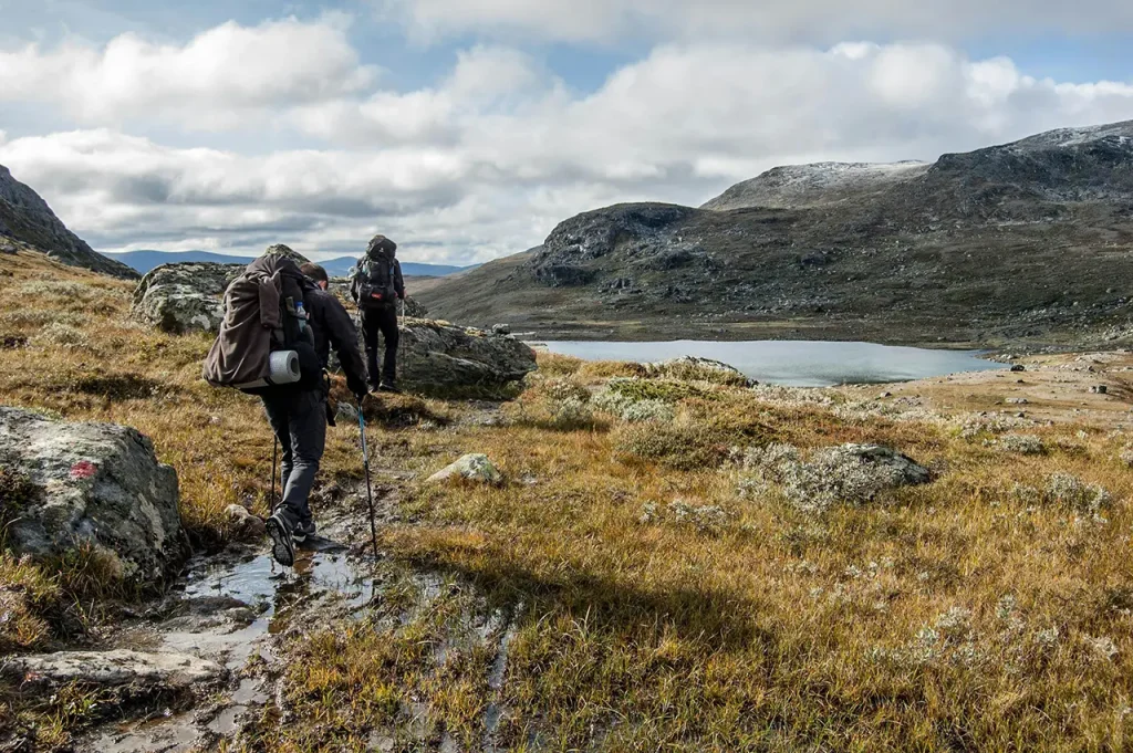 backpacking hikers crossing rocky terrain