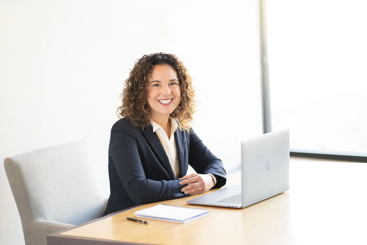 Kimberly Flood at her desk with a laptop
